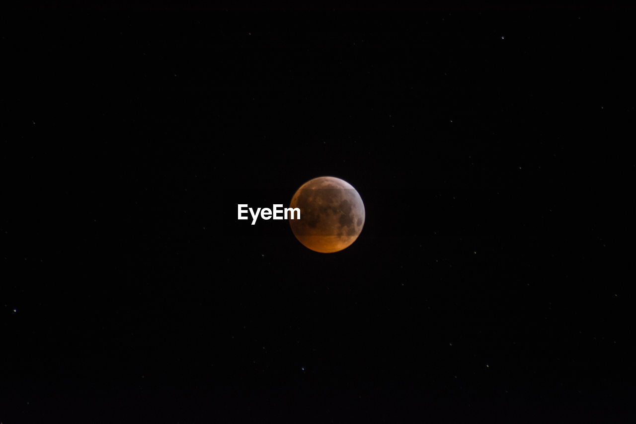 Low angle view of moon against sky at night