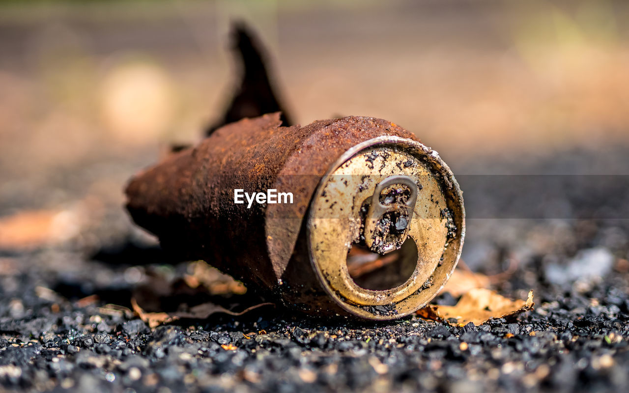 Close-up of rusty and can of coke