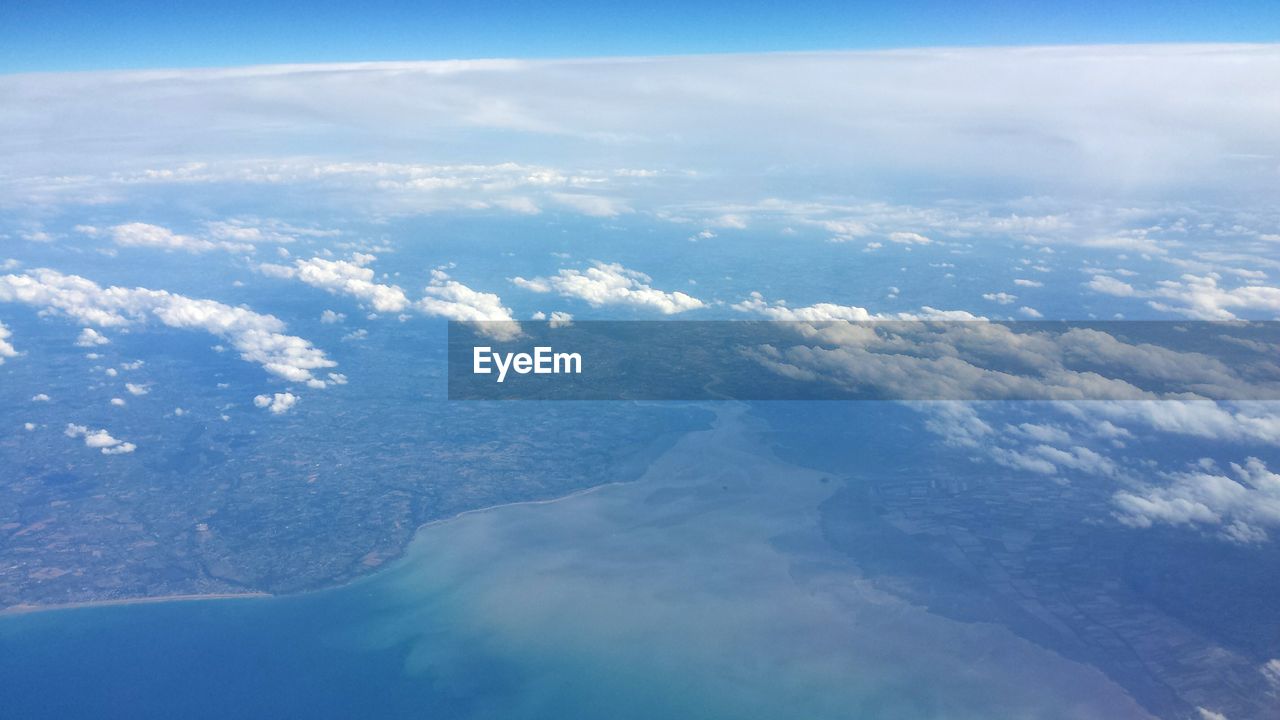 AERIAL VIEW OF CLOUDS AND BLUE SKY SEEN FROM AIRPLANE