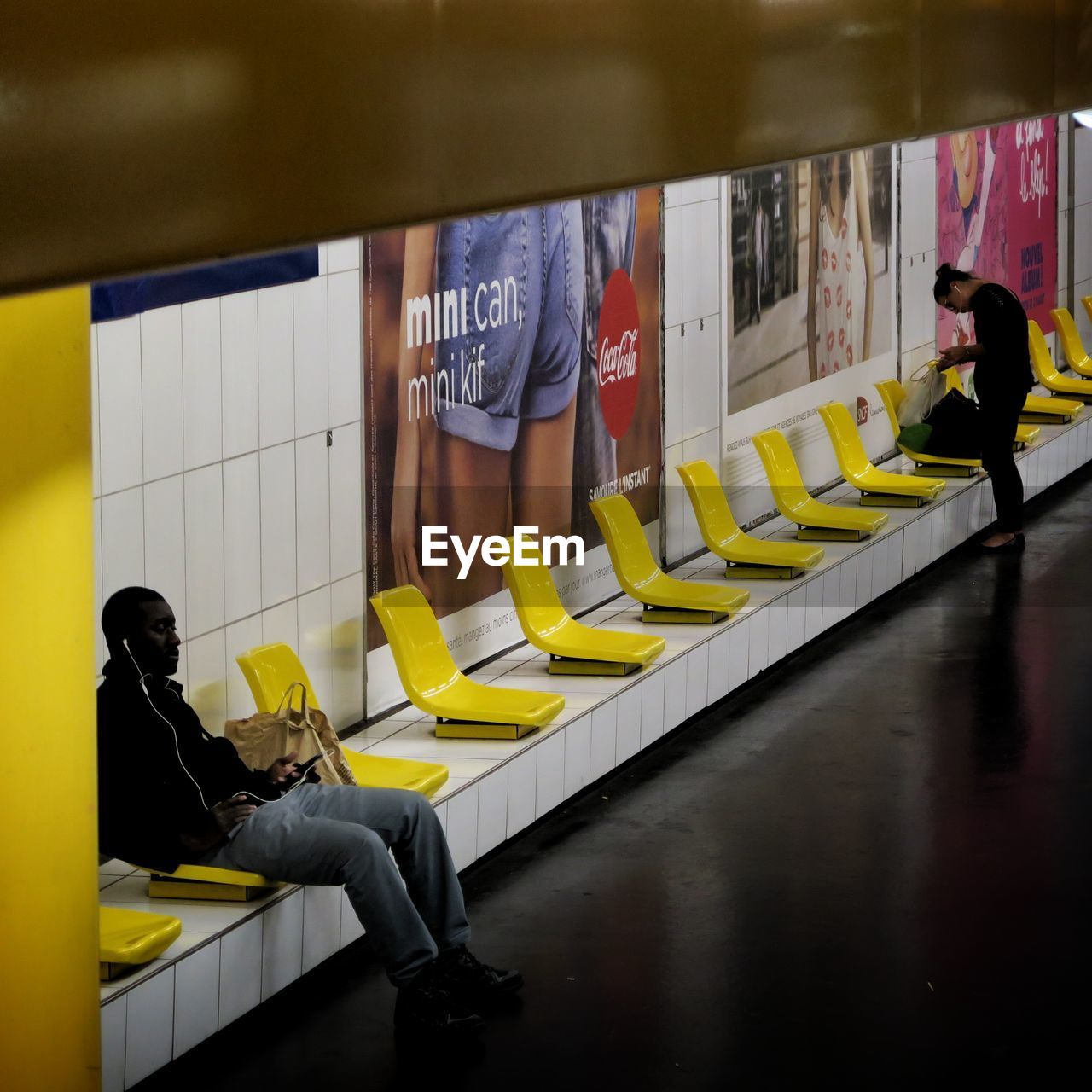 MAN WITH YELLOW UMBRELLA IN BUS