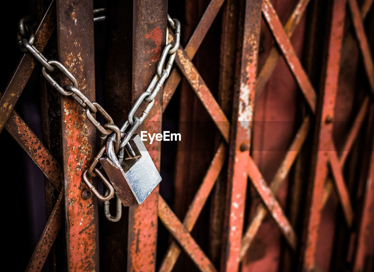 Close-up of padlock on metal fence