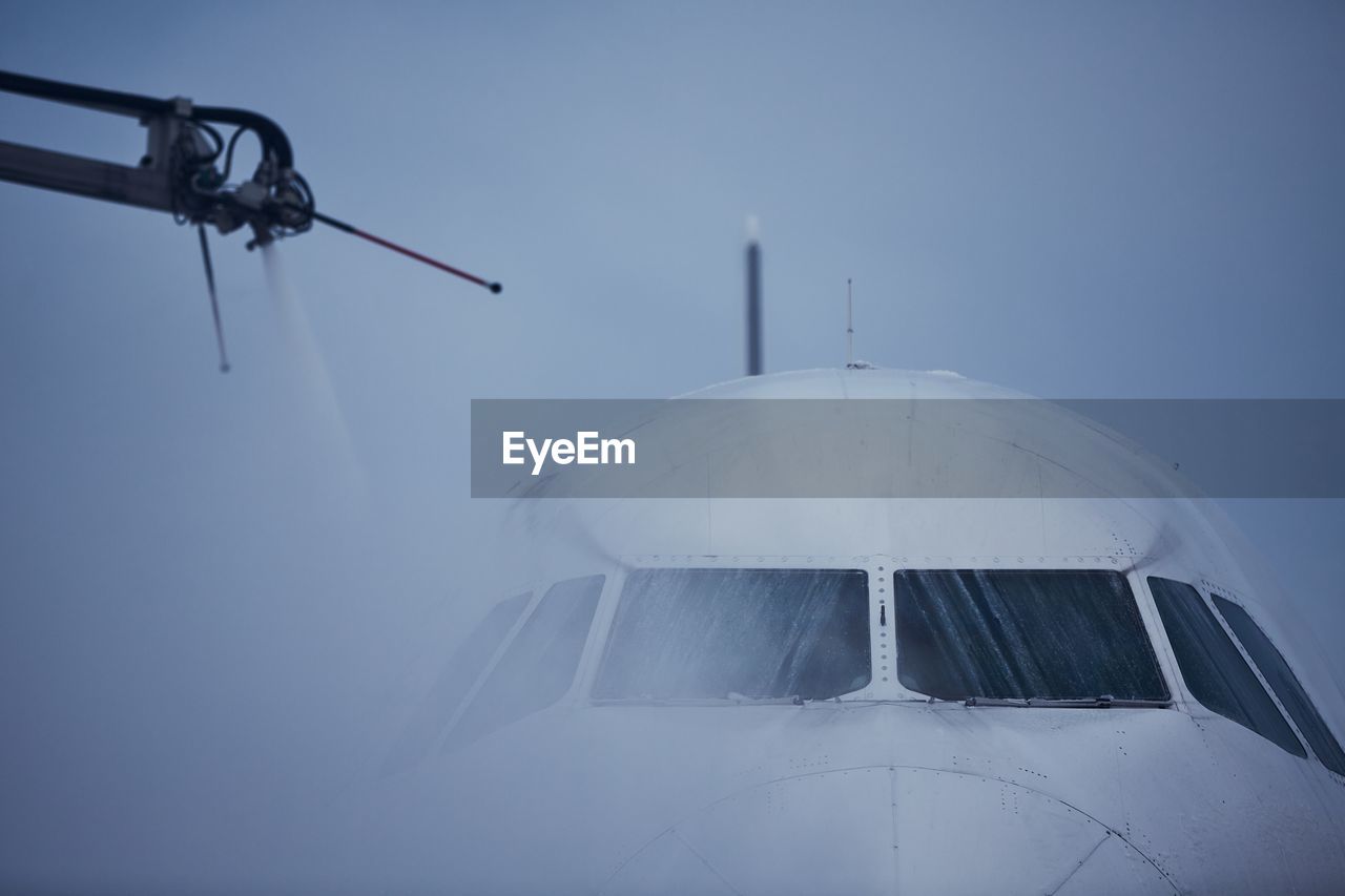 Winter frosty day at airport. deicing of airplane before flight.