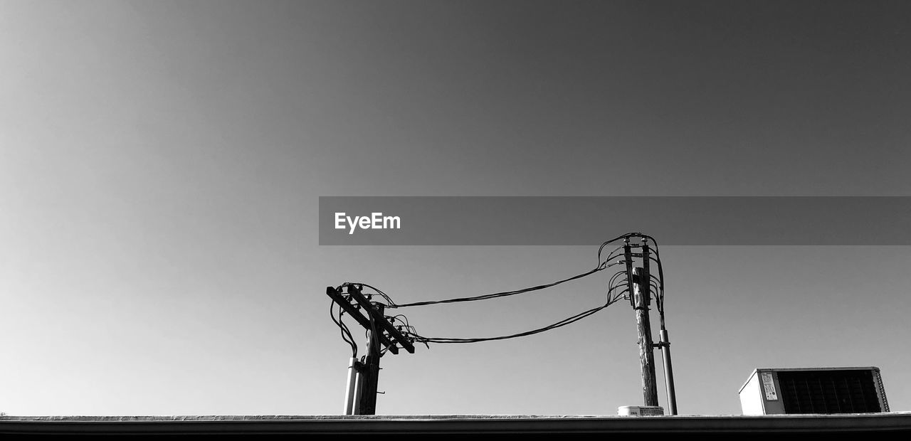 LOW ANGLE VIEW OF SILHOUETTE METAL AGAINST CLEAR SKY