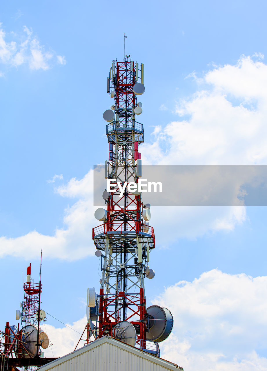 Cell tower with antenna against blue sky