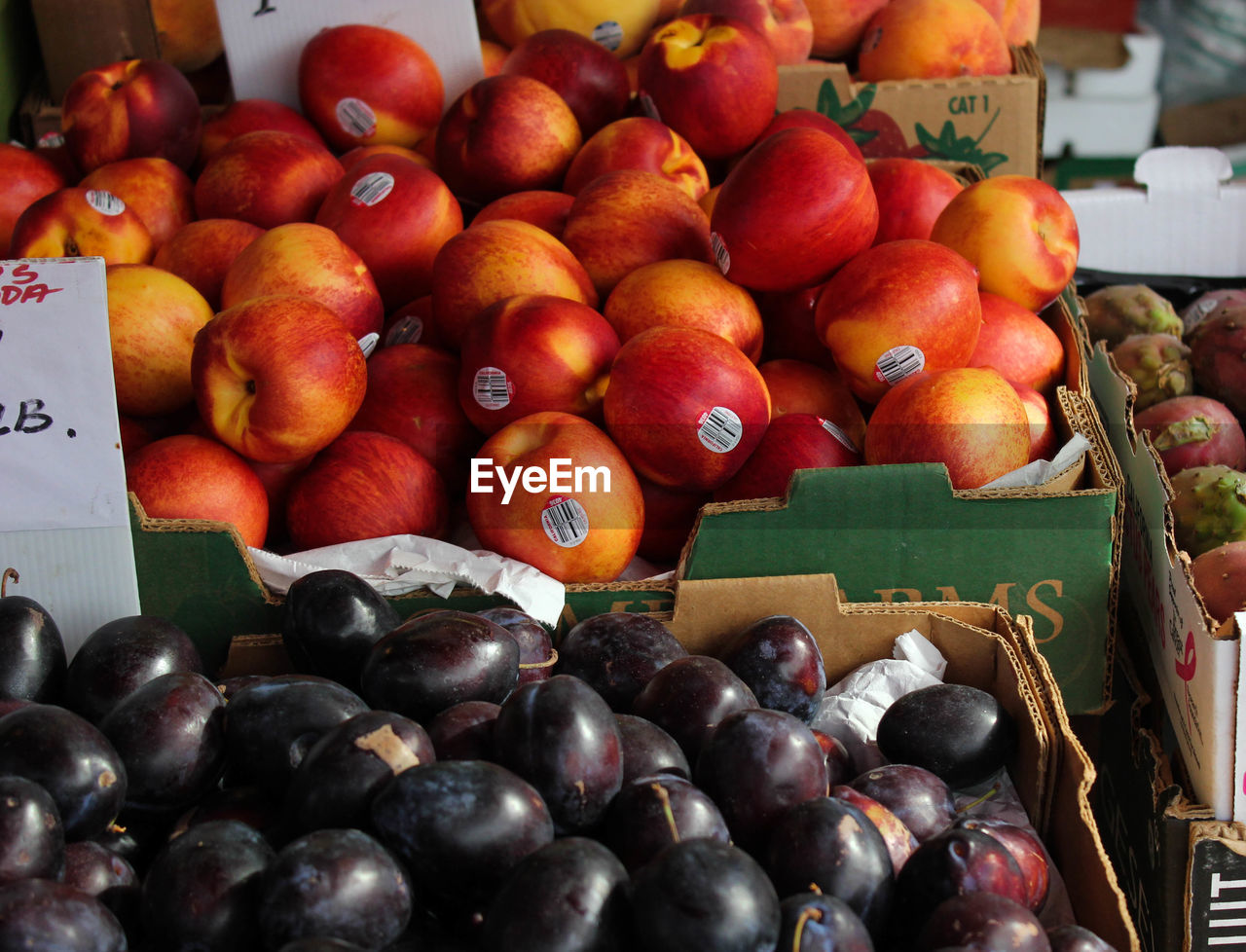 High angle view of plum and apple for sale