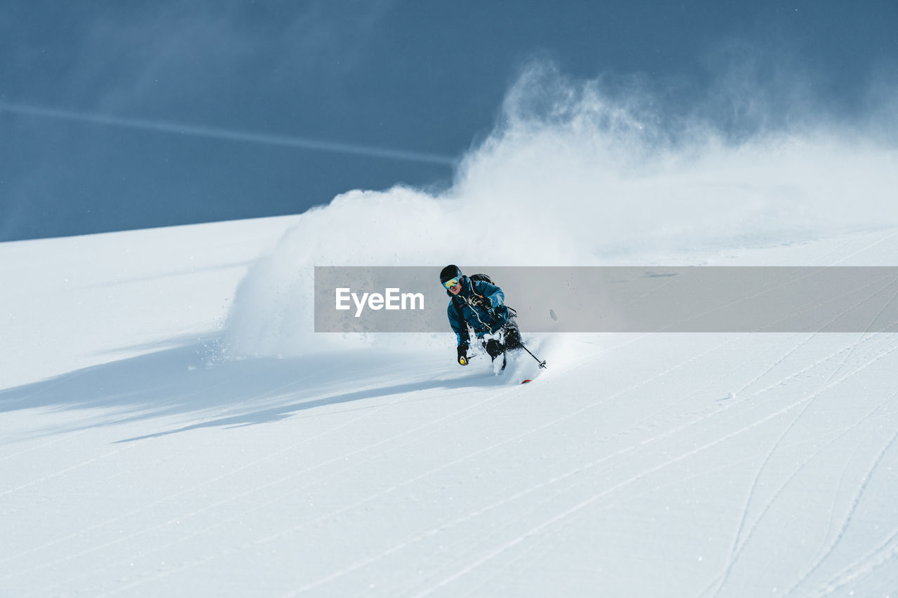 Man enjoying skiing in deep powder snow, gastein, salzburg, austria