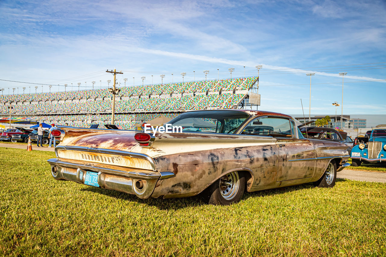 ABANDONED CAR ON FIELD