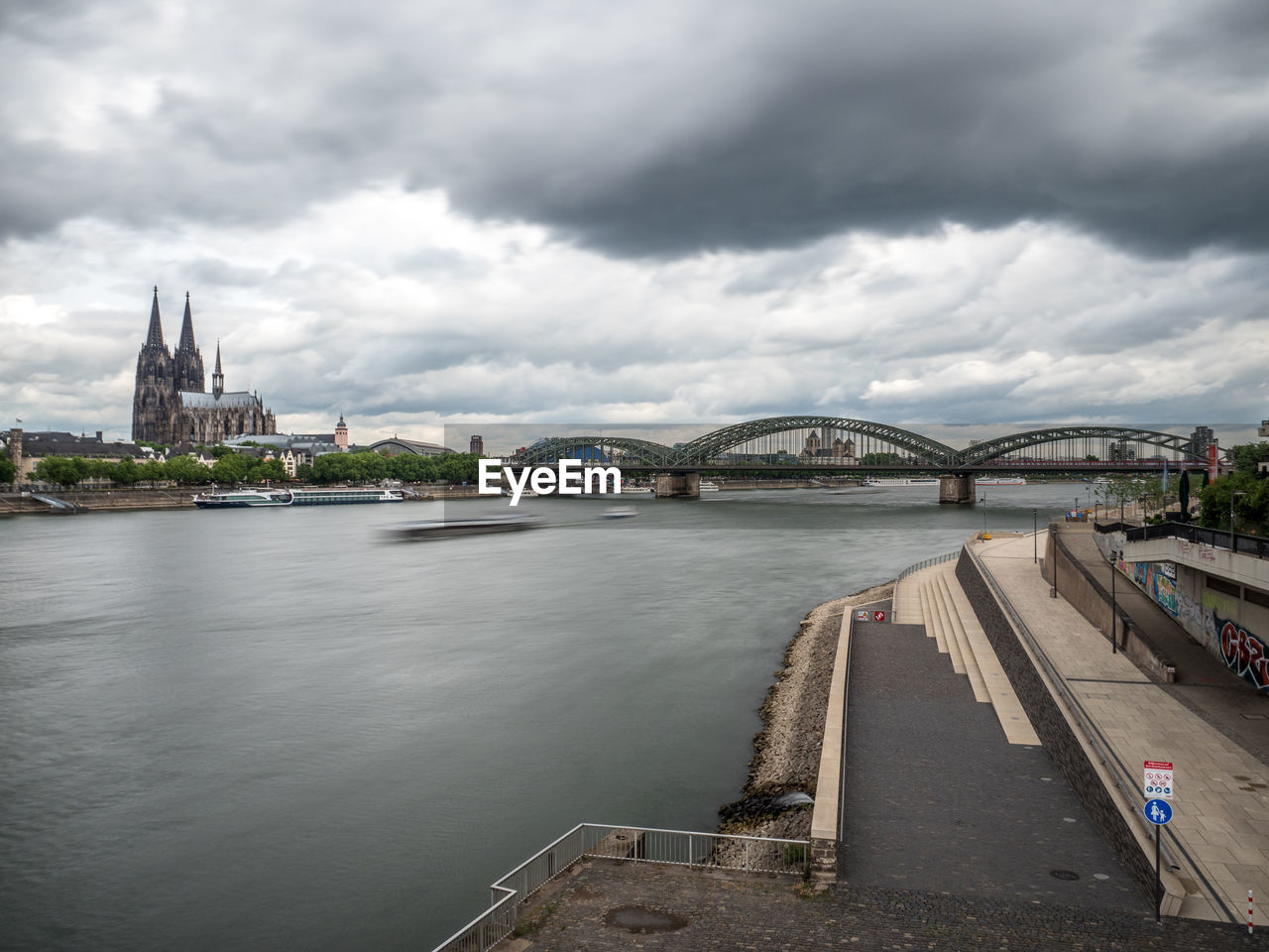 View of bridge over river against cloudy sky