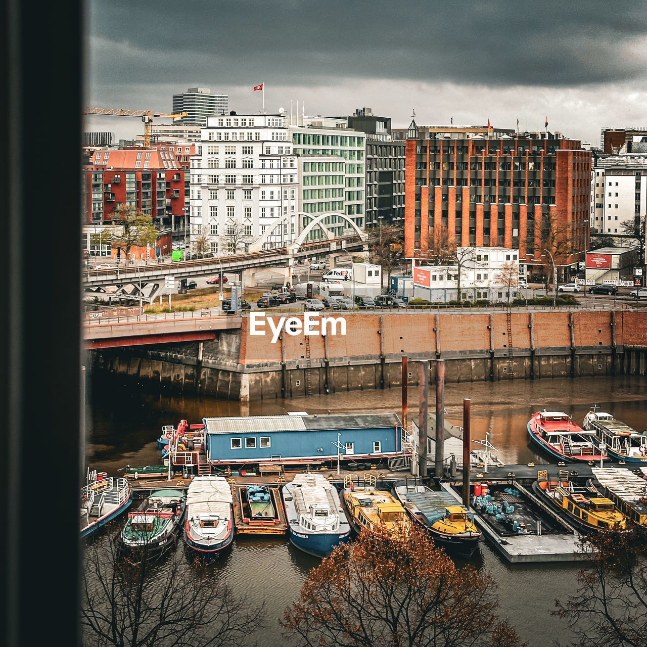 architecture, urban area, cityscape, built structure, building exterior, city, transportation, mode of transportation, building, sky, water, vehicle, nautical vessel, cloud, no people, nature, car, motor vehicle, residential district, transport, travel destinations, downtown, reflection, land vehicle, day, outdoors, moored, street, travel, skyline, city life, ship, river, high angle view