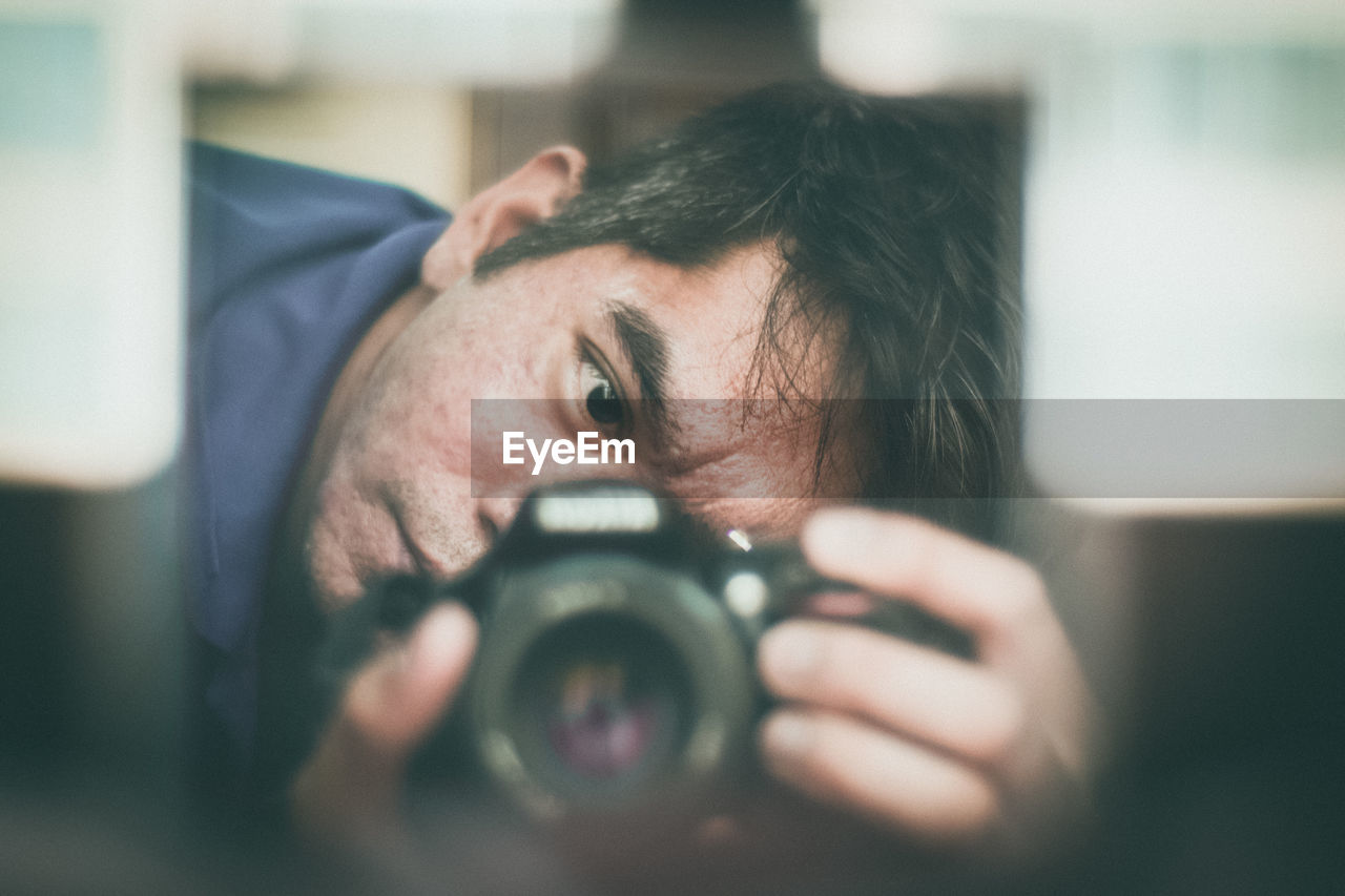 Close-up of man photographing at home