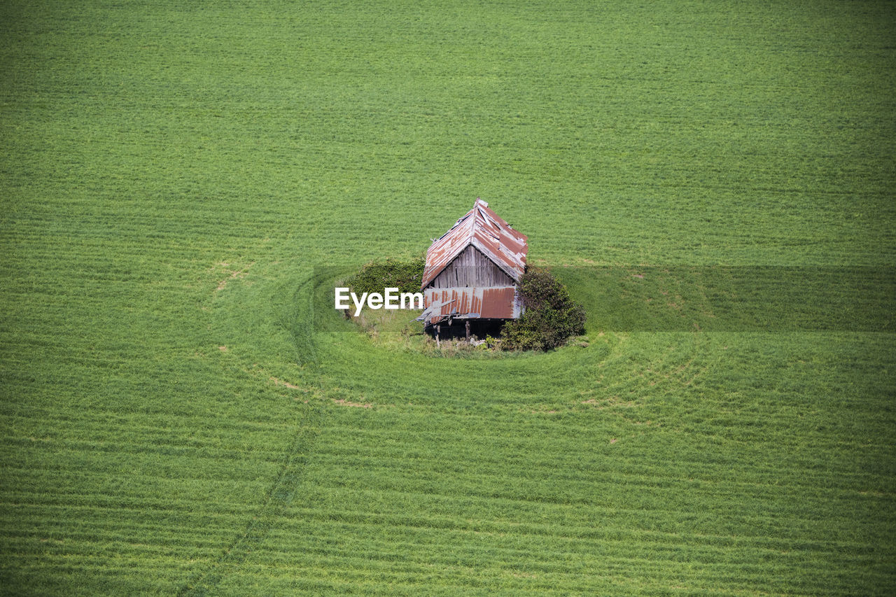 Aerial view of old barn in farm field.