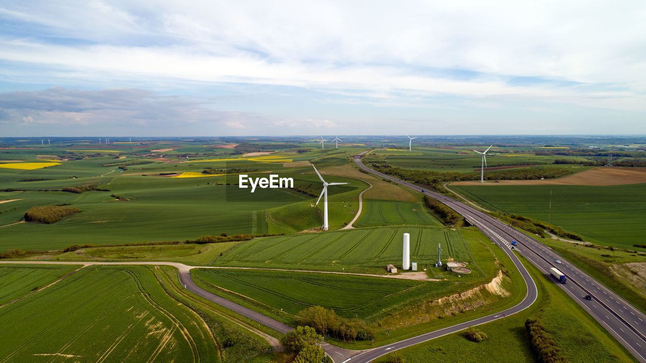 High angle view of wind turbines on field against sky