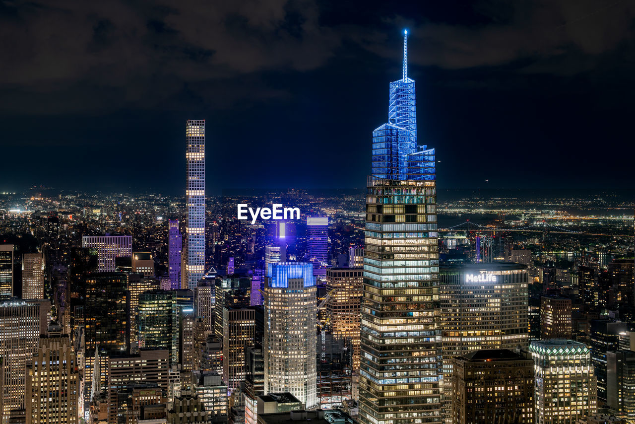 Manhattan - illuminated cityscape against sky at night