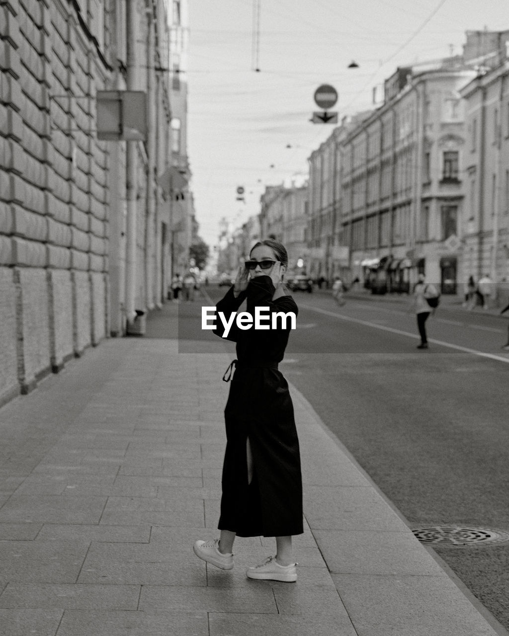 Rear view of woman walking on street in city