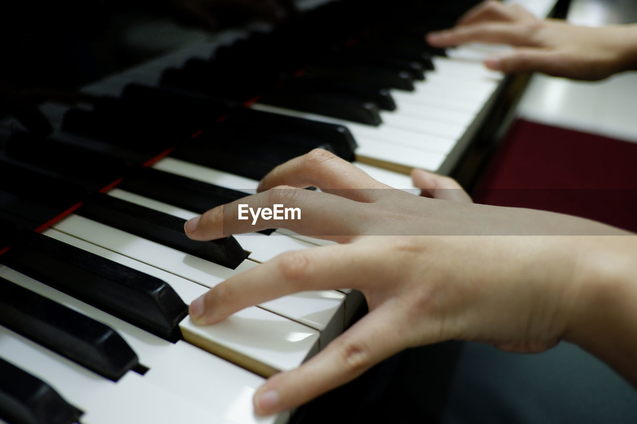 Cropped hand playing piano