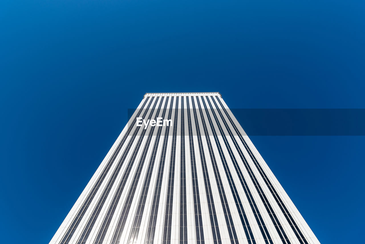 Low angle view of modern building against blue sky