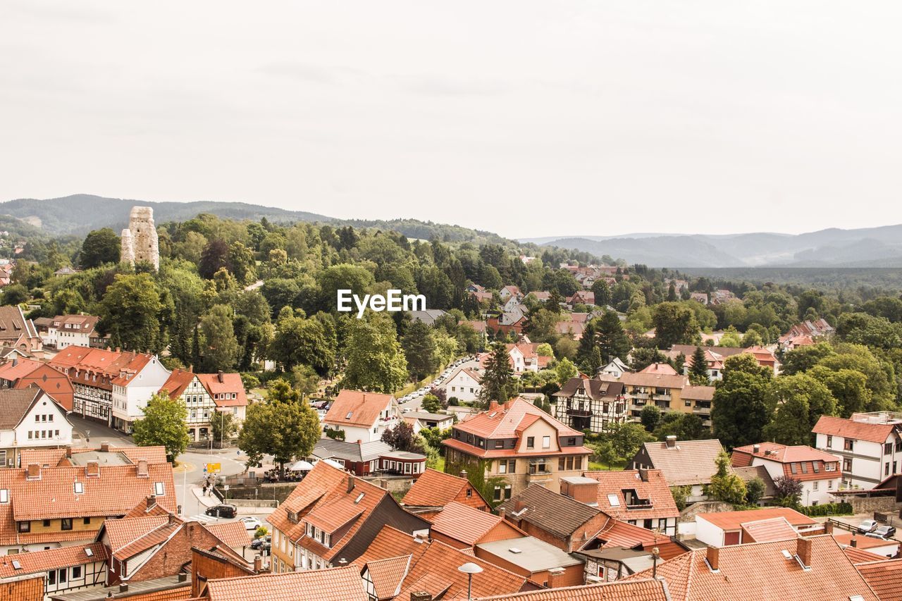 High angle view of houses in town against sky