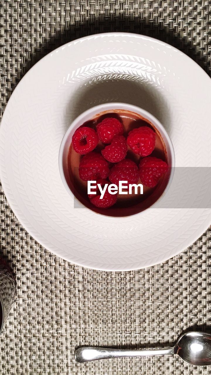 CLOSE-UP OF RASPBERRIES IN PLATE