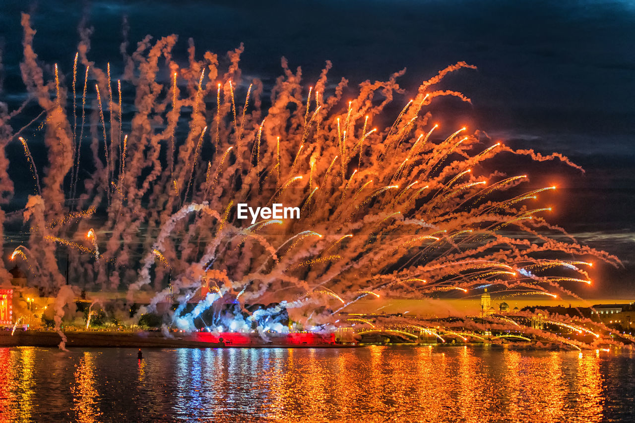 FIREWORK DISPLAY OVER LAKE AGAINST SKY