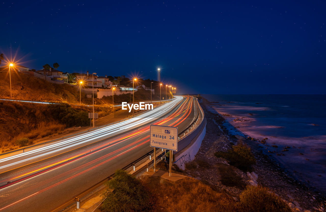 High angle view of light trails on road at night