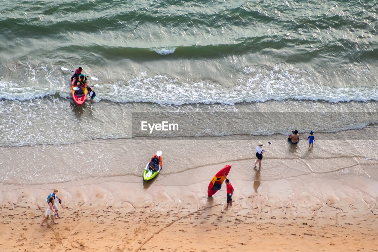 HIGH ANGLE VIEW OF PEOPLE ENJOYING AT BEACH