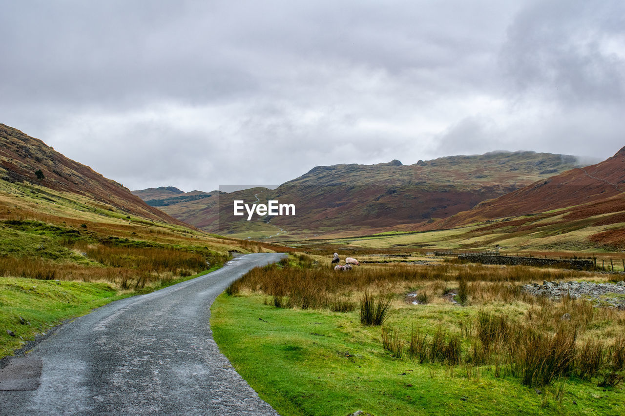 EMPTY ROAD LEADING TOWARDS MOUNTAIN AGAINST SKY