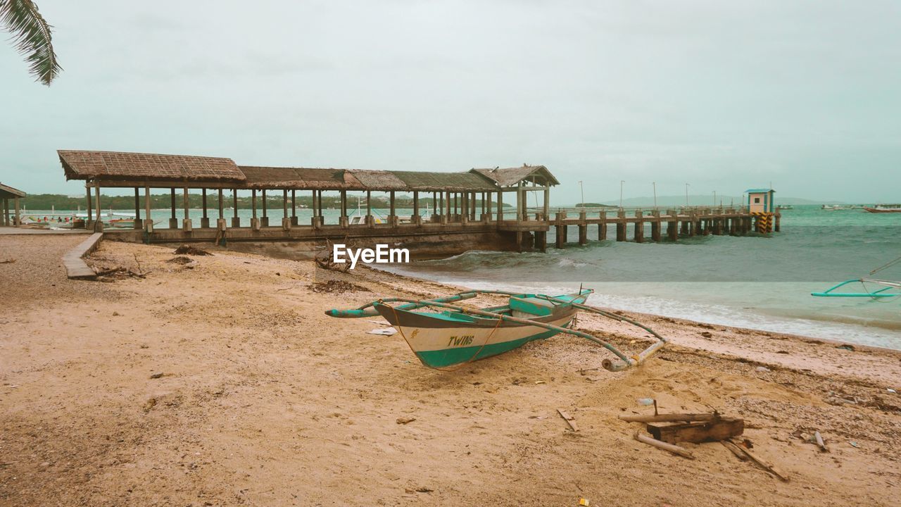 DECK CHAIRS ON SHORE AGAINST SKY