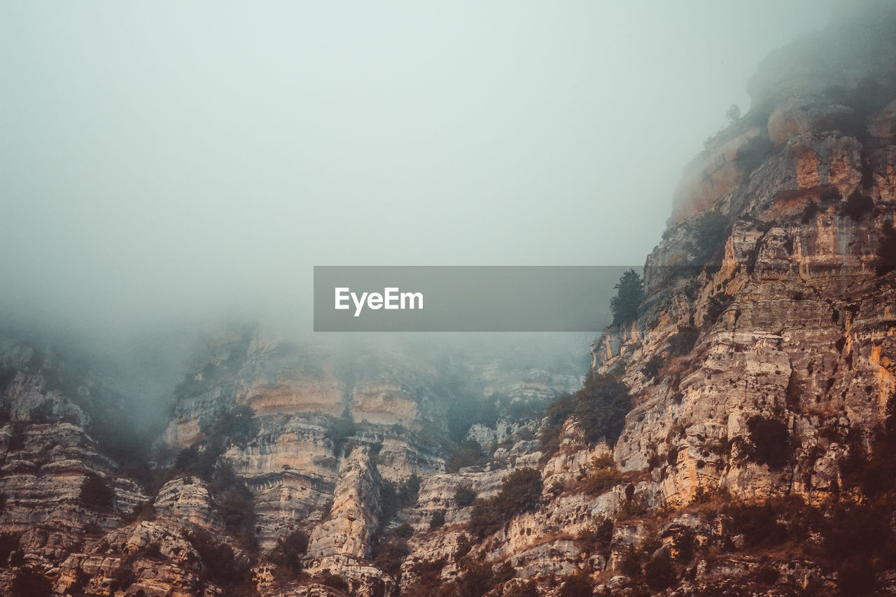 Scenic view of mountains against sky during foggy weather