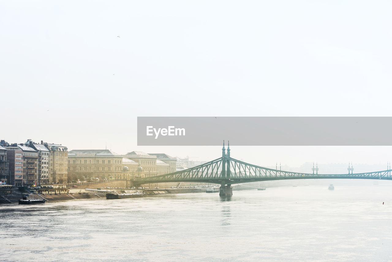 Bridge over river against clear sky