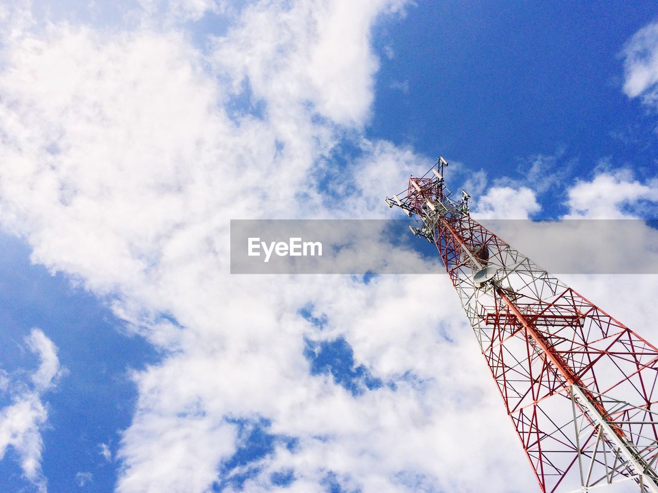 Low angle view of communications tower against blue sky