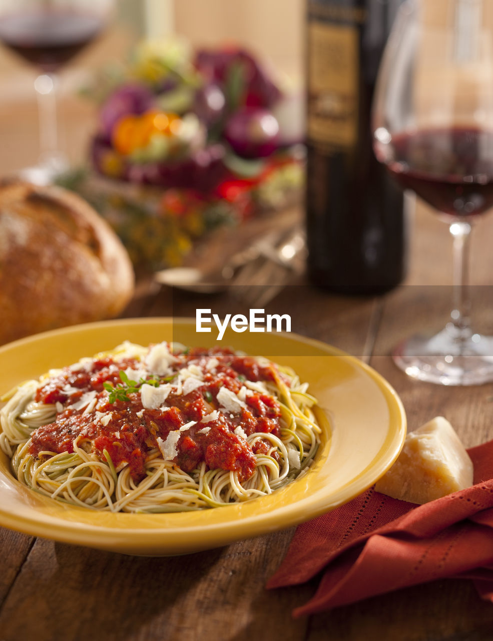 Close-up of pasta by wine on table