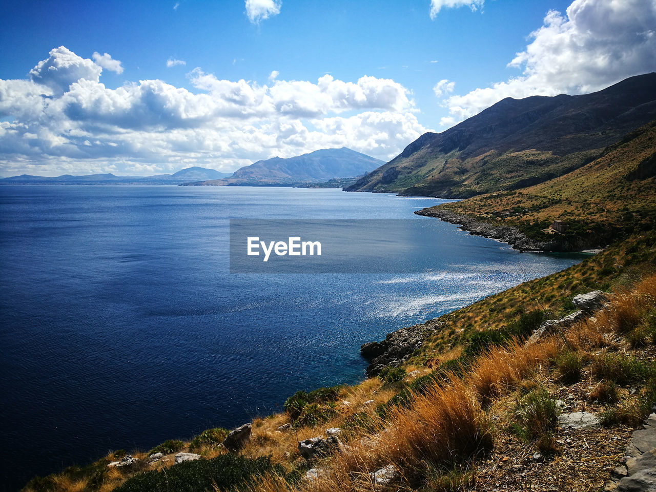 Scenic view of lake and mountains against sky