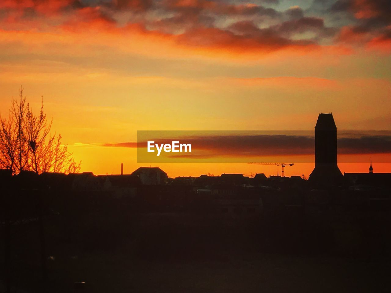 SILHOUETTE BUILT STRUCTURES AGAINST ORANGE SKY