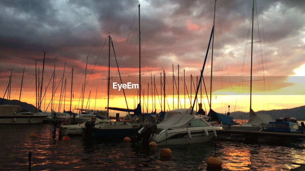 SAILBOATS IN MARINA AT SUNSET