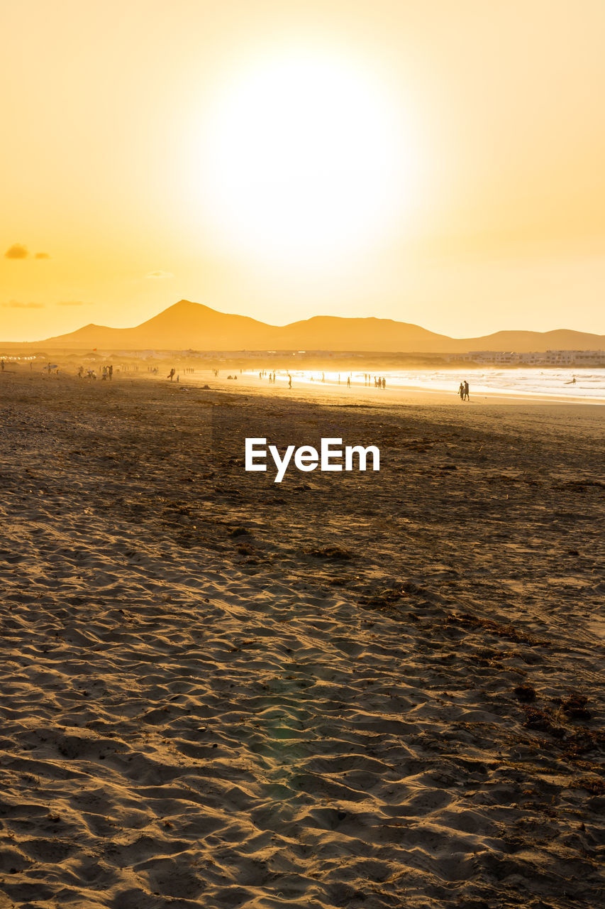 SCENIC VIEW OF BEACH DURING SUNSET