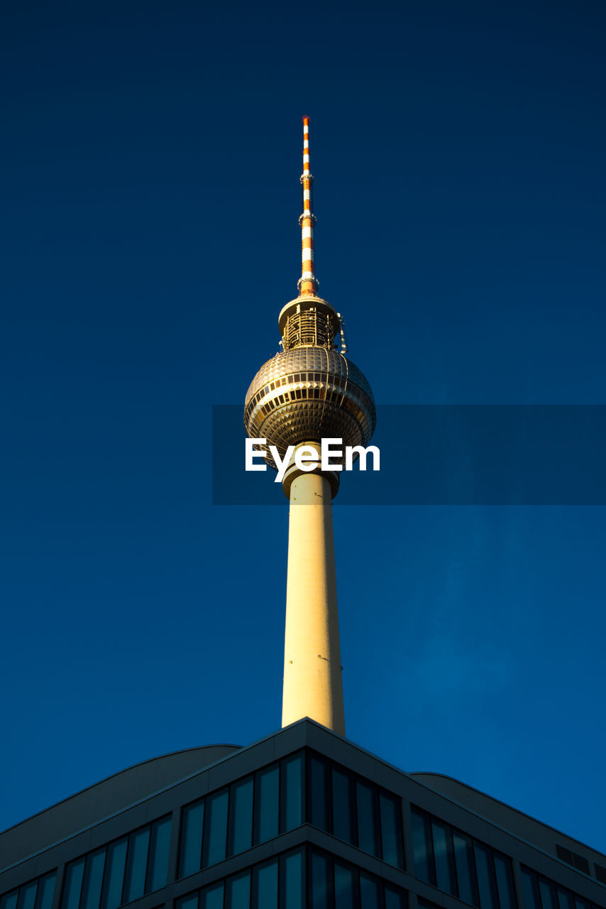 Low angle view of communications tower against sky