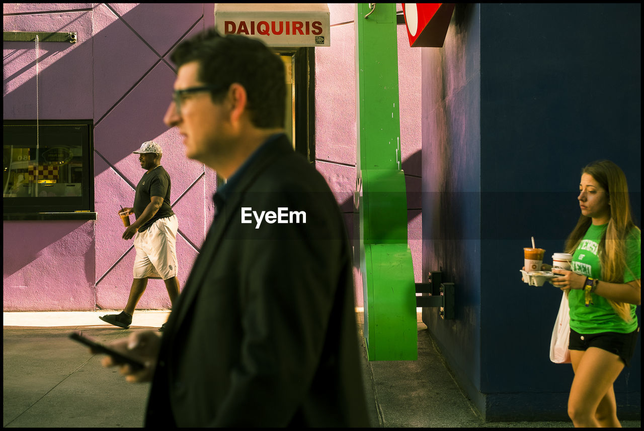 MEN STANDING AT RESTAURANT