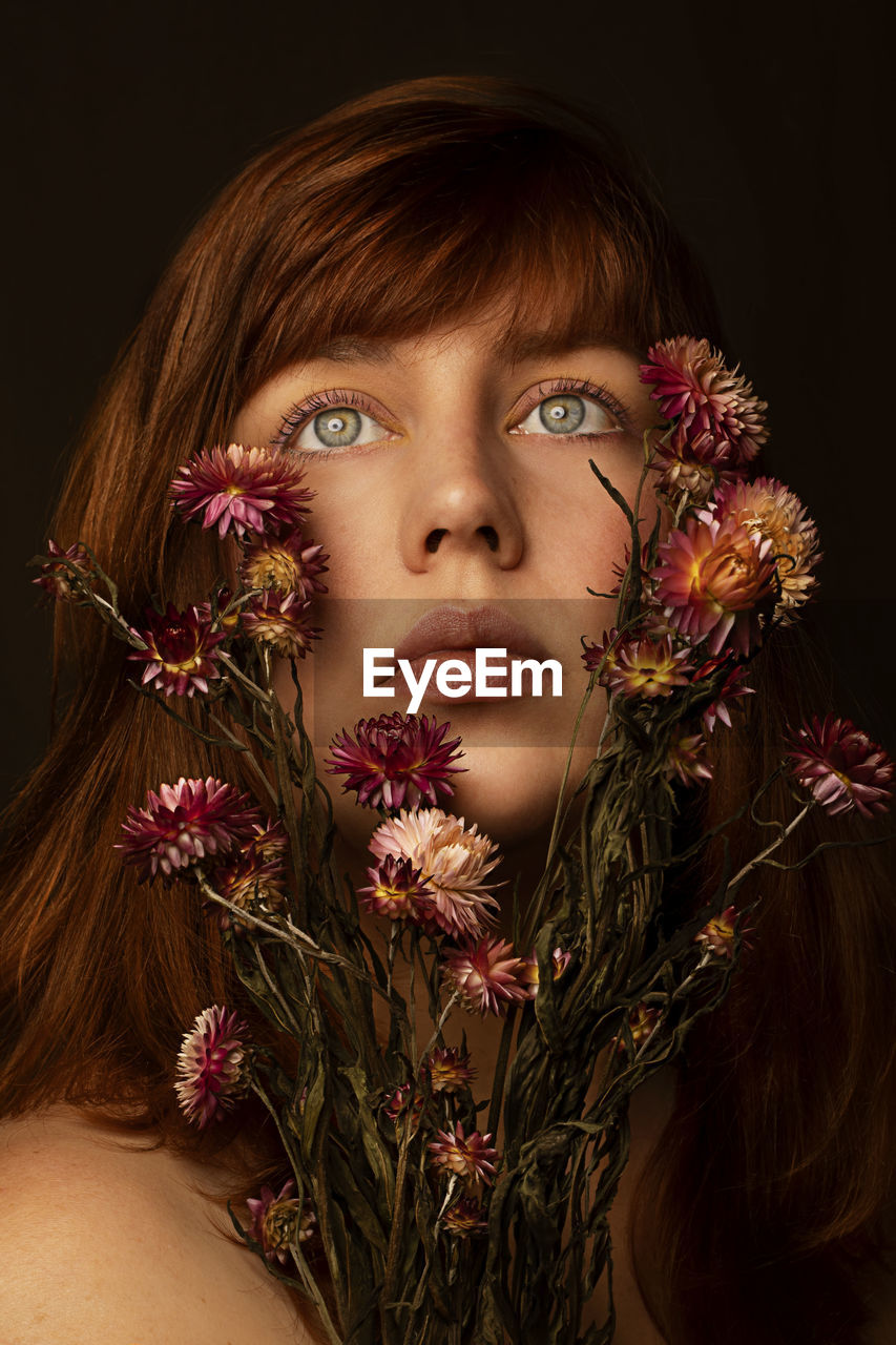 Close-up of woman with flowers