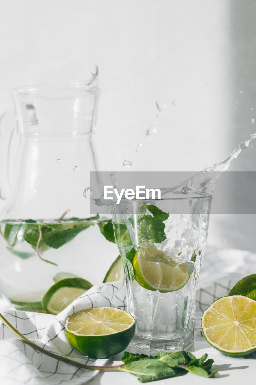 GLASS OF FRUIT AND DRINK ON TABLE AT WATER