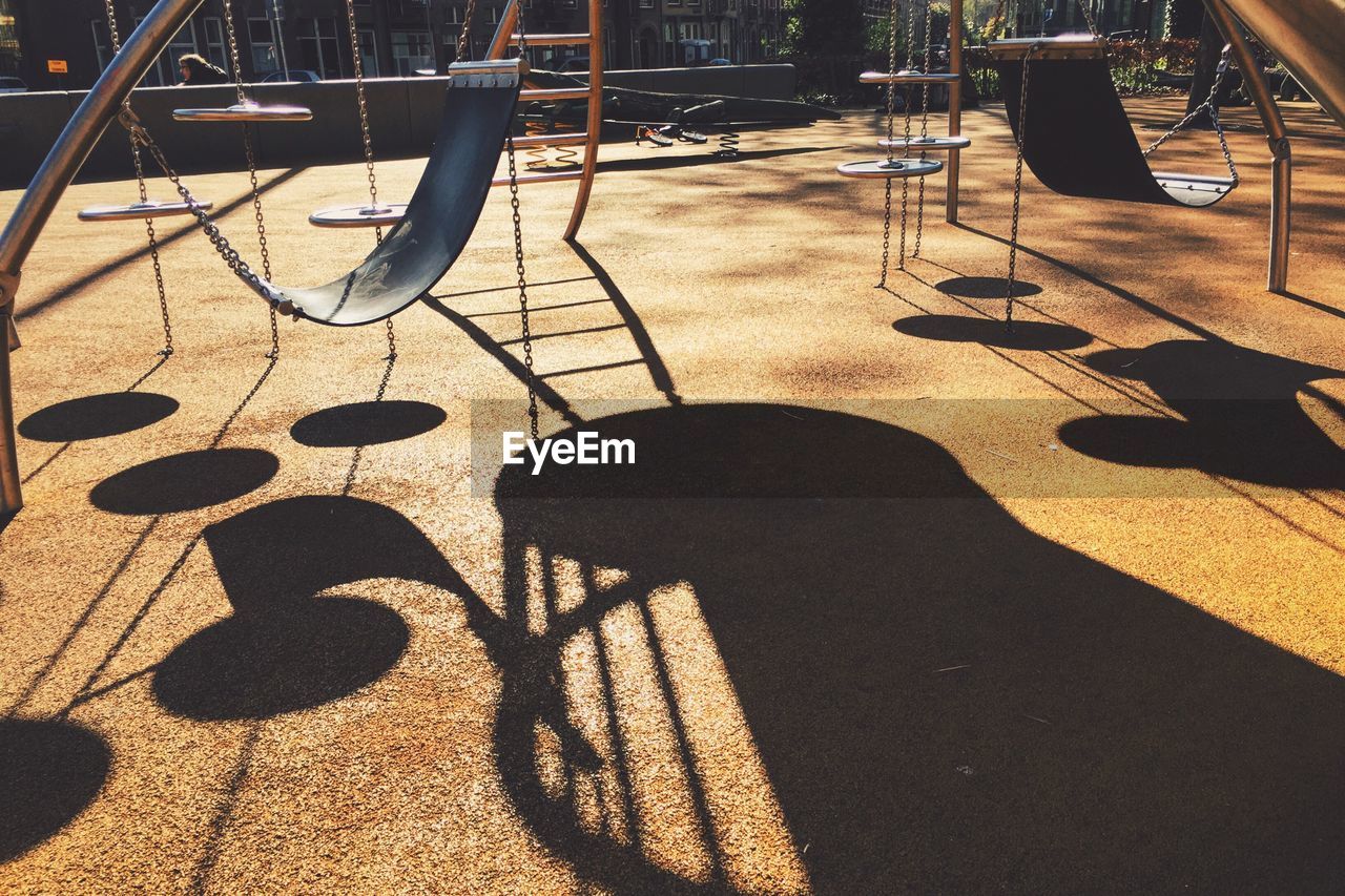 Shadow of swings on playground