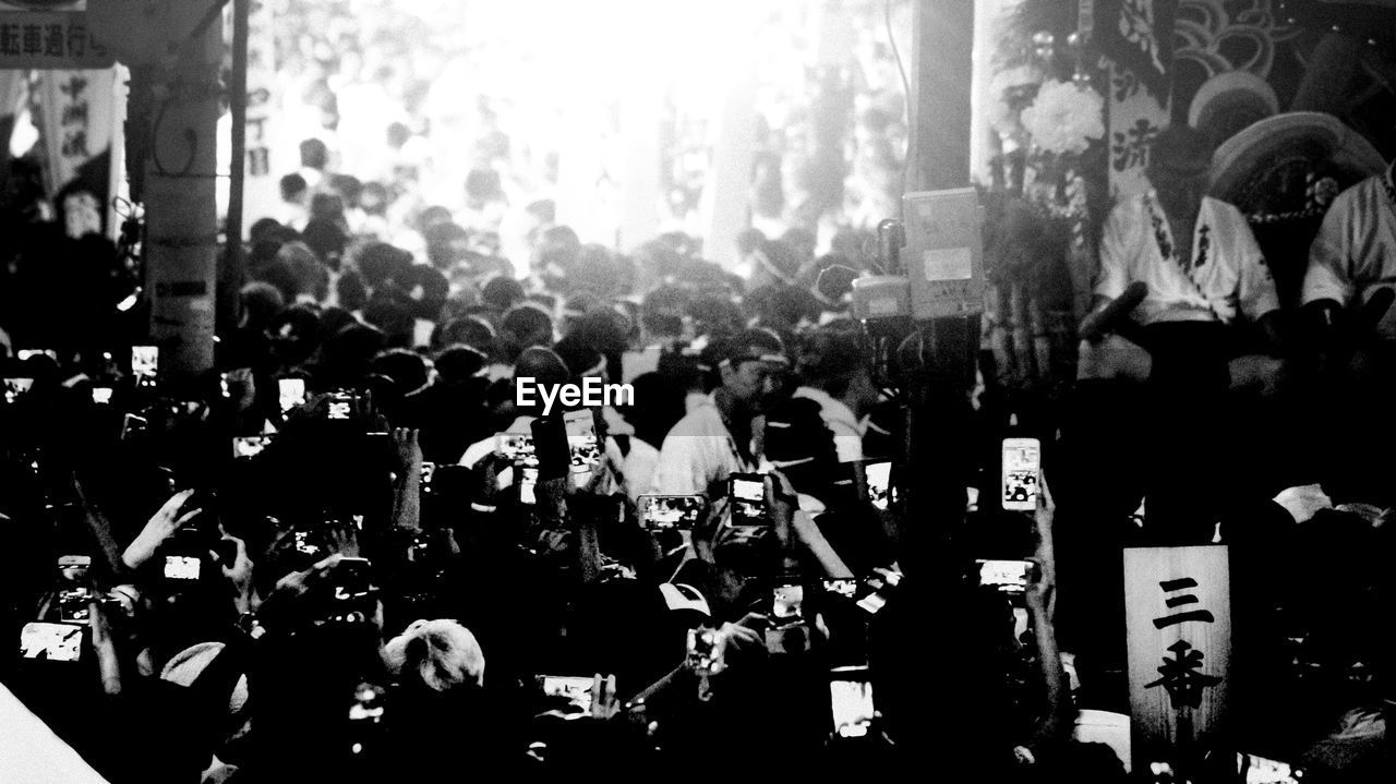 Crowd holding cameras during event