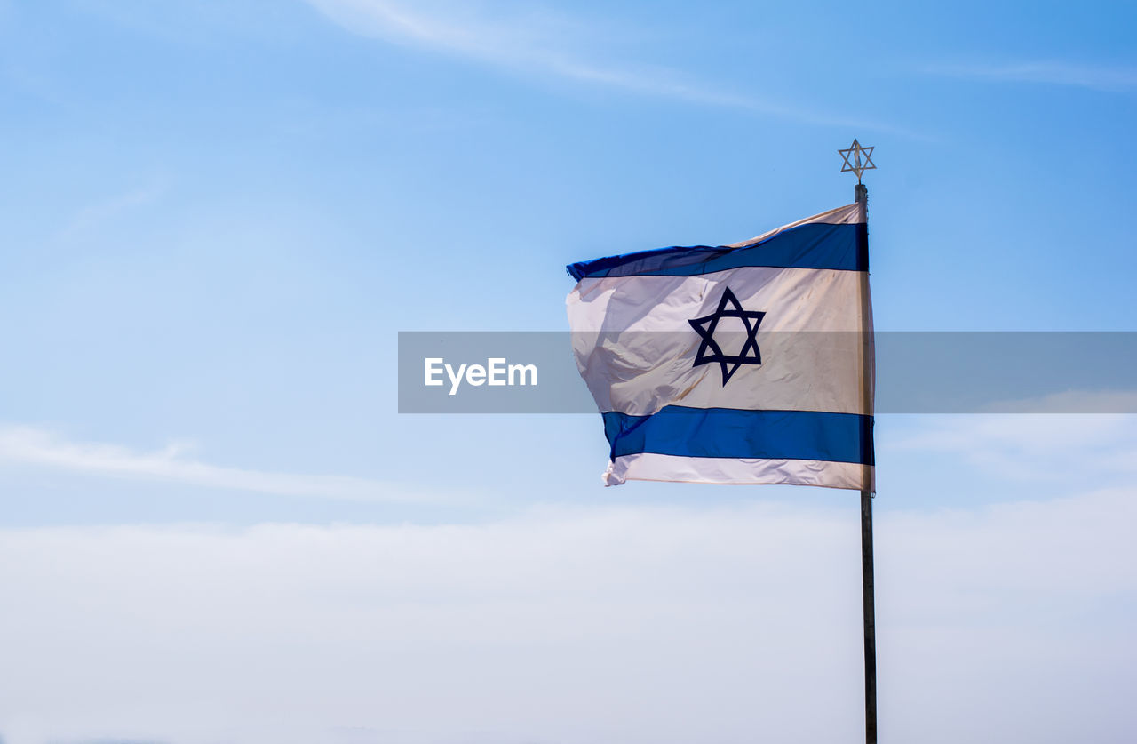 Low angle view of flag against sky