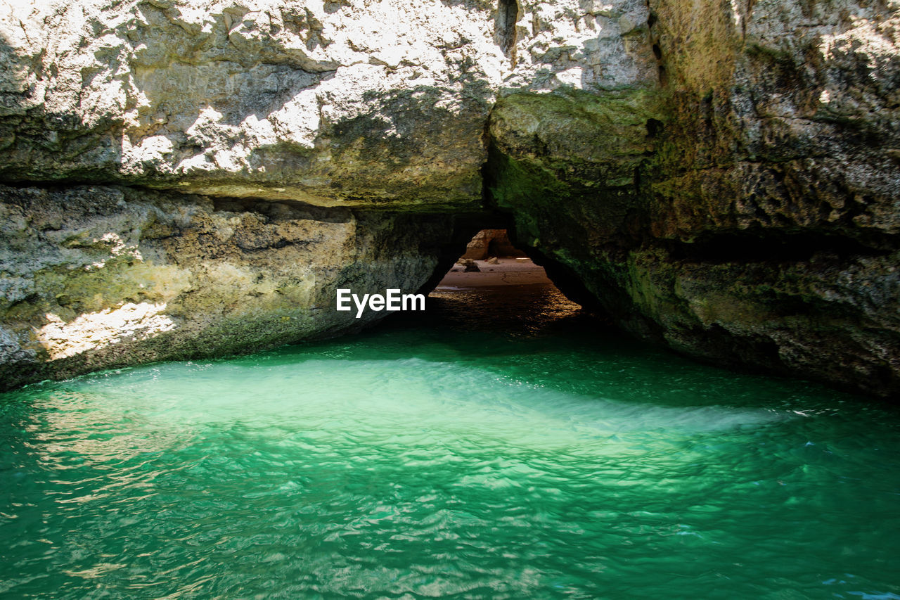 SCENIC VIEW OF CAVE AND RIVER