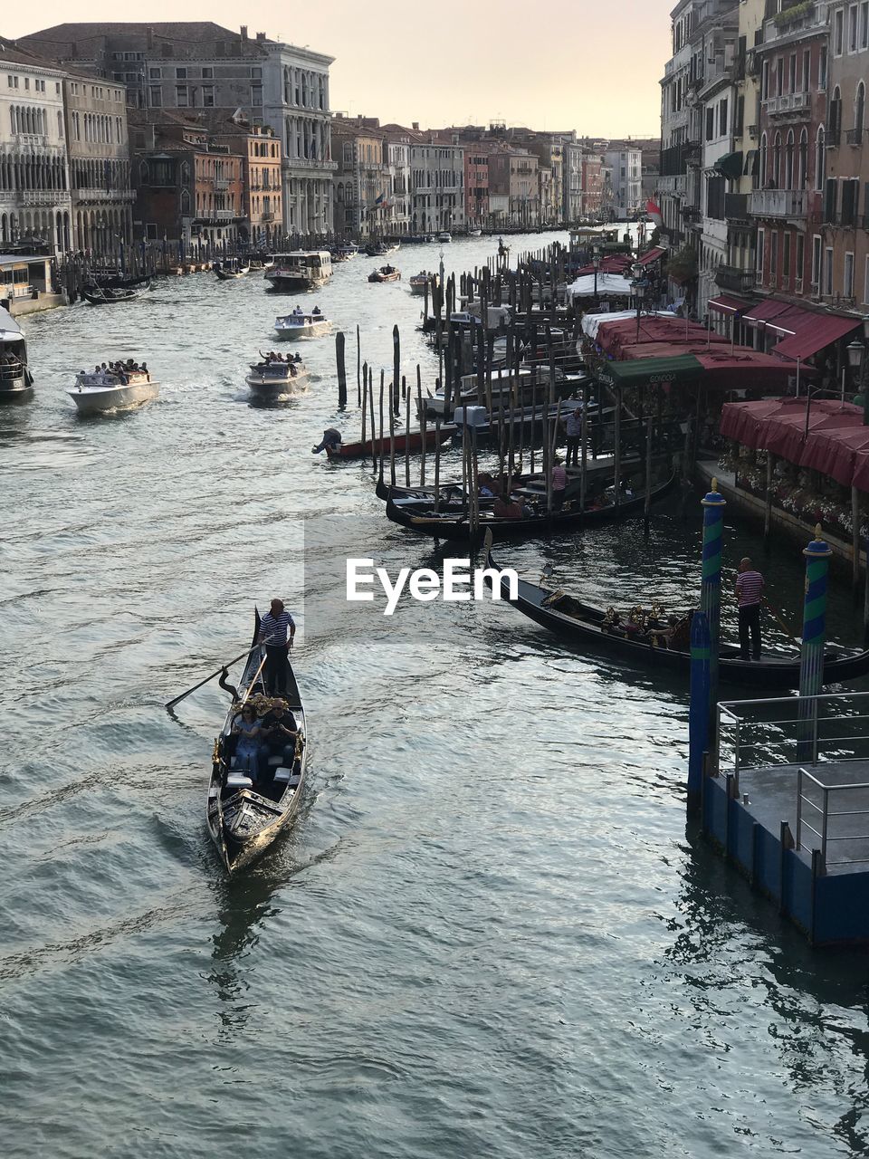 MAN ON BOAT MOORED ON SHORE