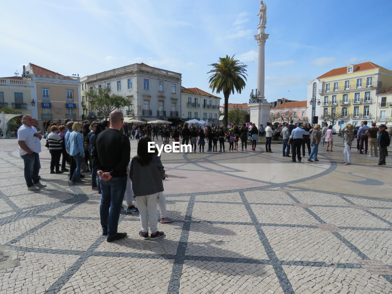 PEOPLE WALKING IN TOWN SQUARE