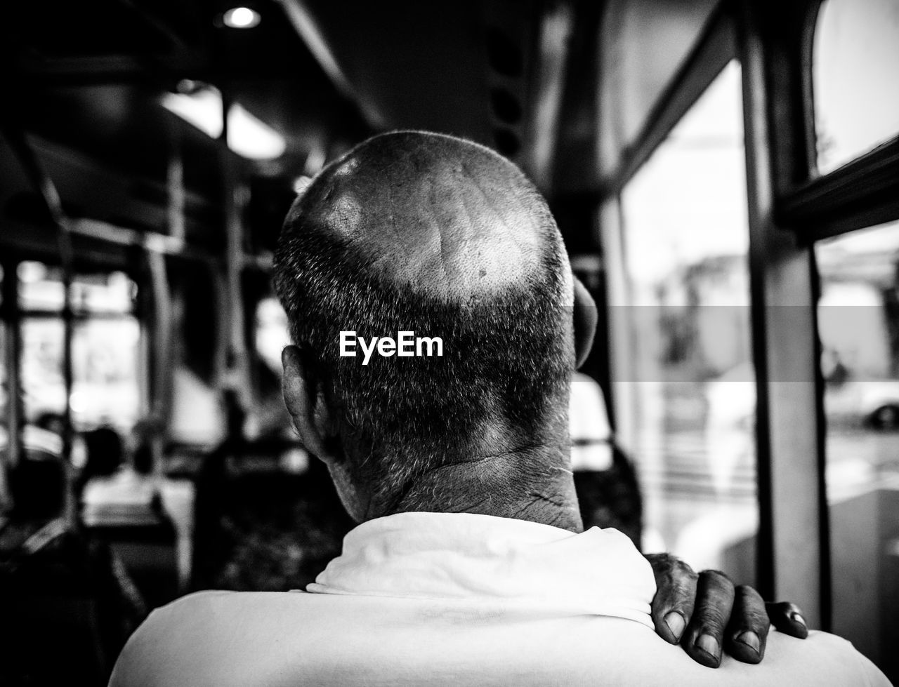 Rear view of man sitting in bus