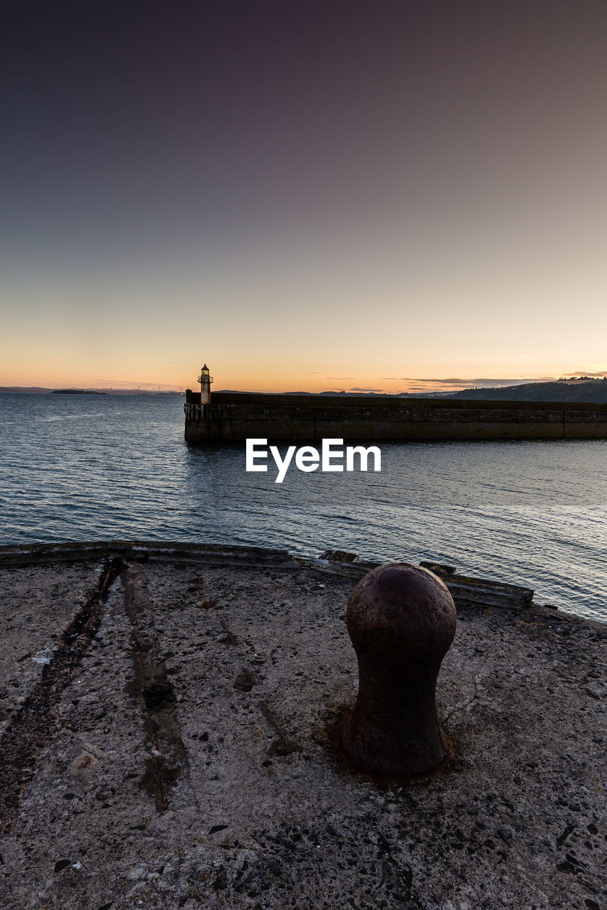 Scenic view of sea against clear sky during sunset