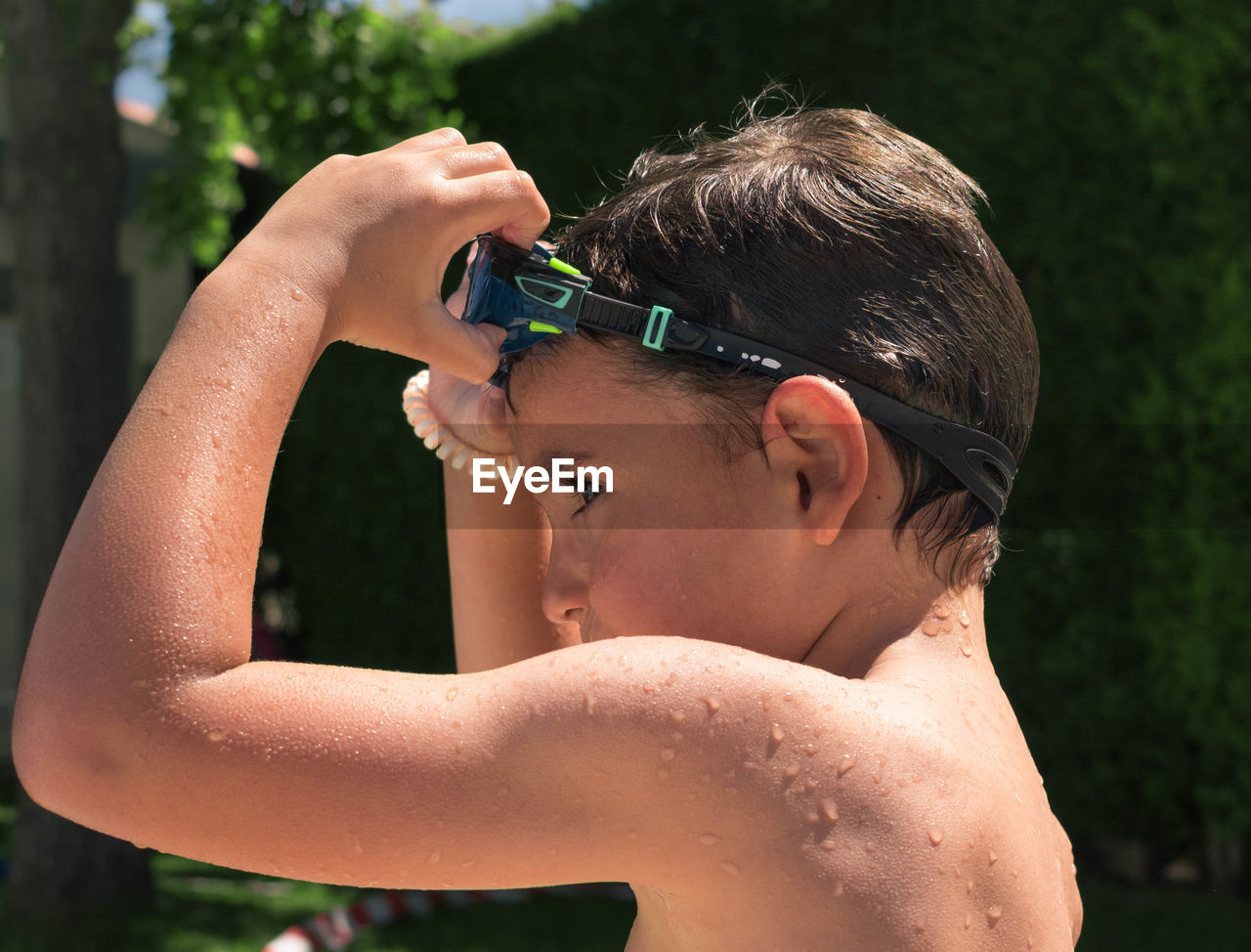 Portrait of shirtless boy in water