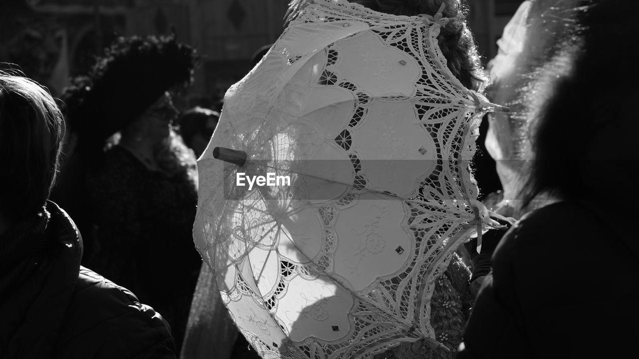 Umbrella amidst people in city