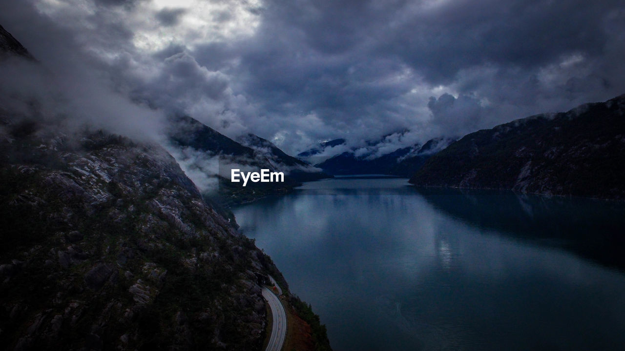 Scenic view of mountains against cloudy sky